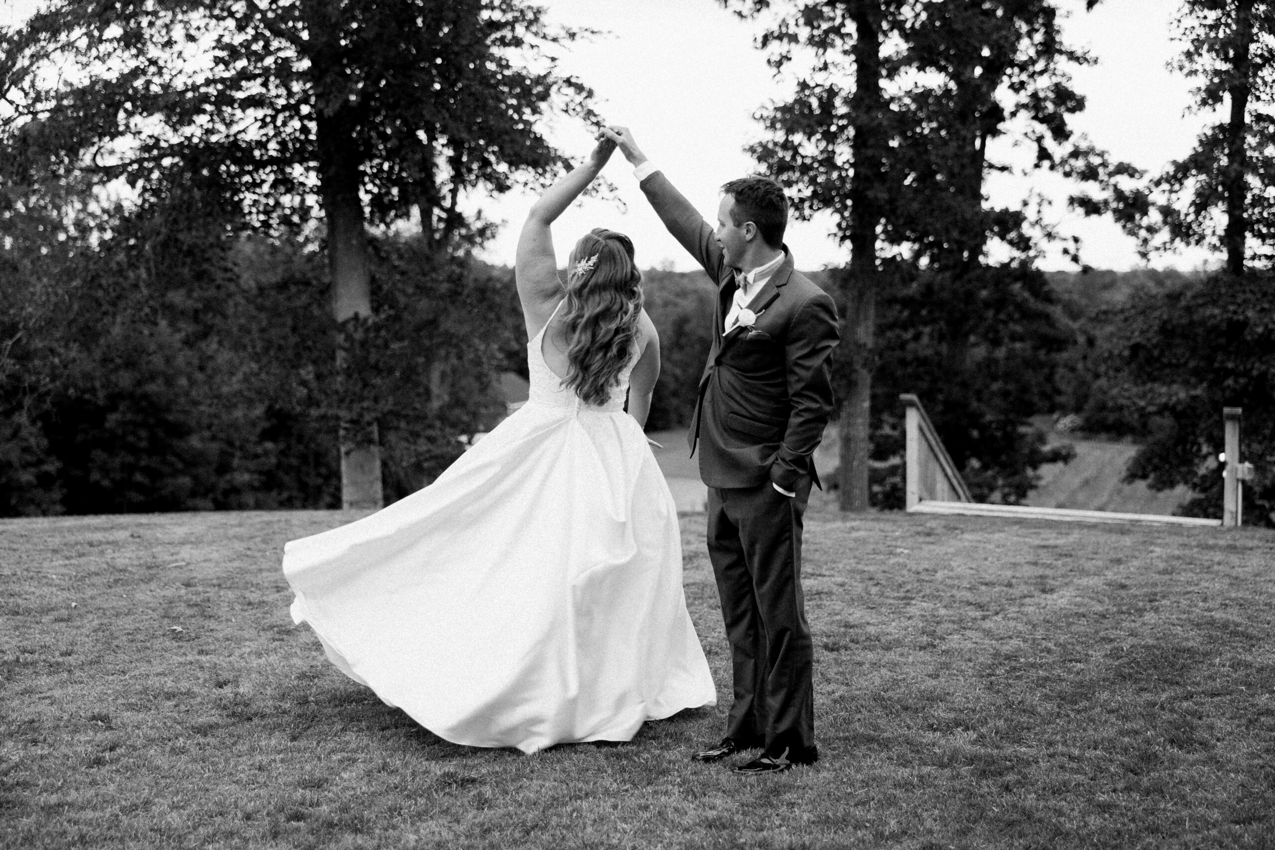 Groom spinning bride around by Virginia Wedding Company