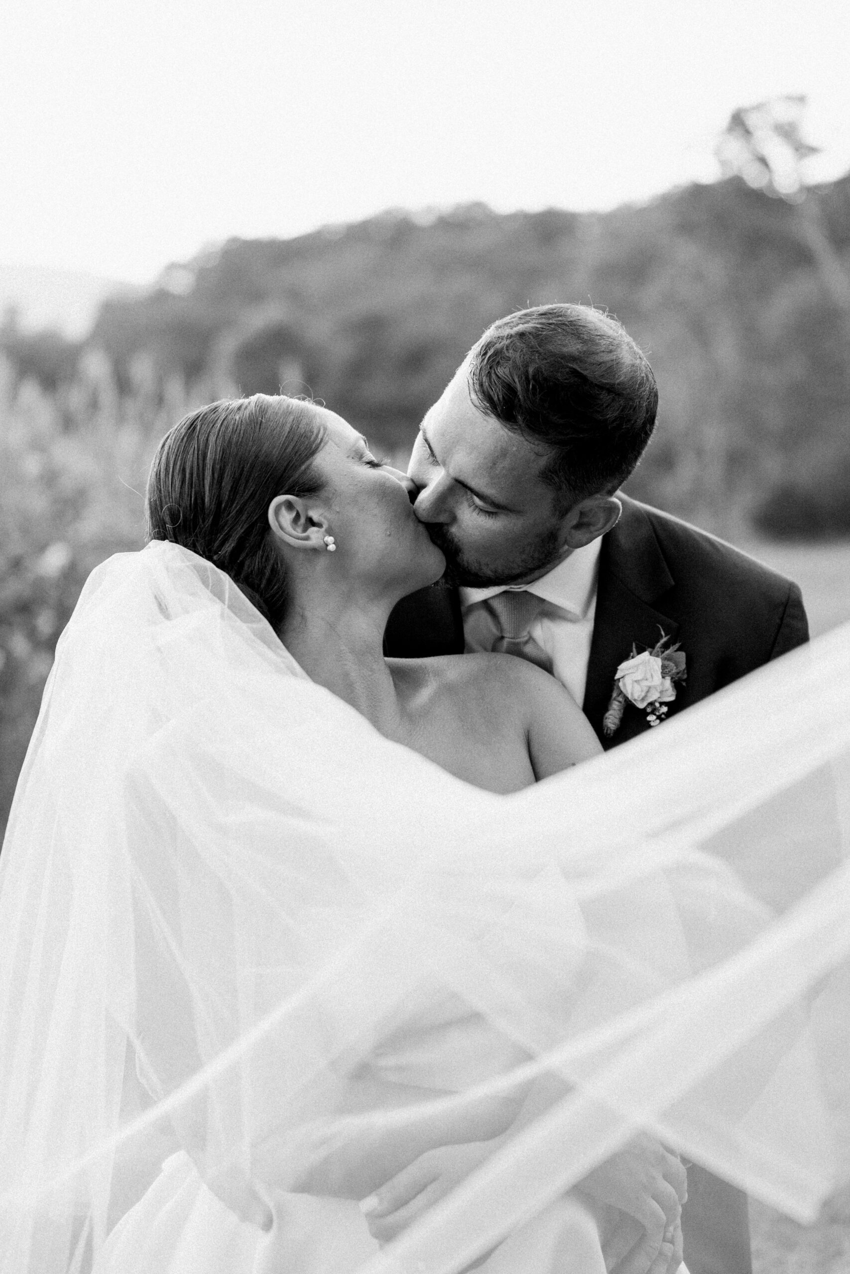 Bride and groom kissing in the Shenandoah Woods by Virginia Wedding Company