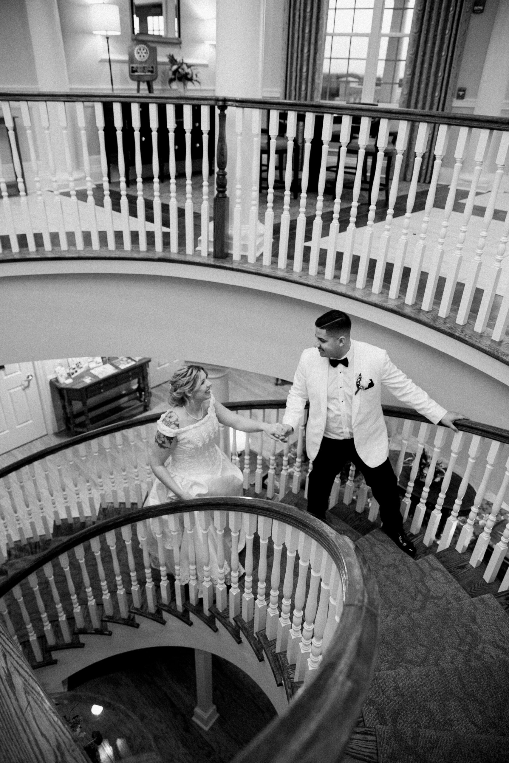 Bride and groom walking up stairs by Virginia Wedding Company