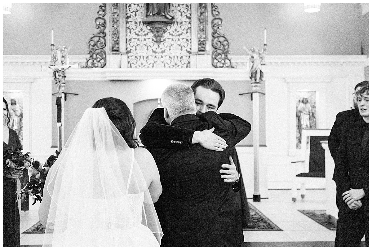 Groom hugging father-in-law by Virginia Wedding Company