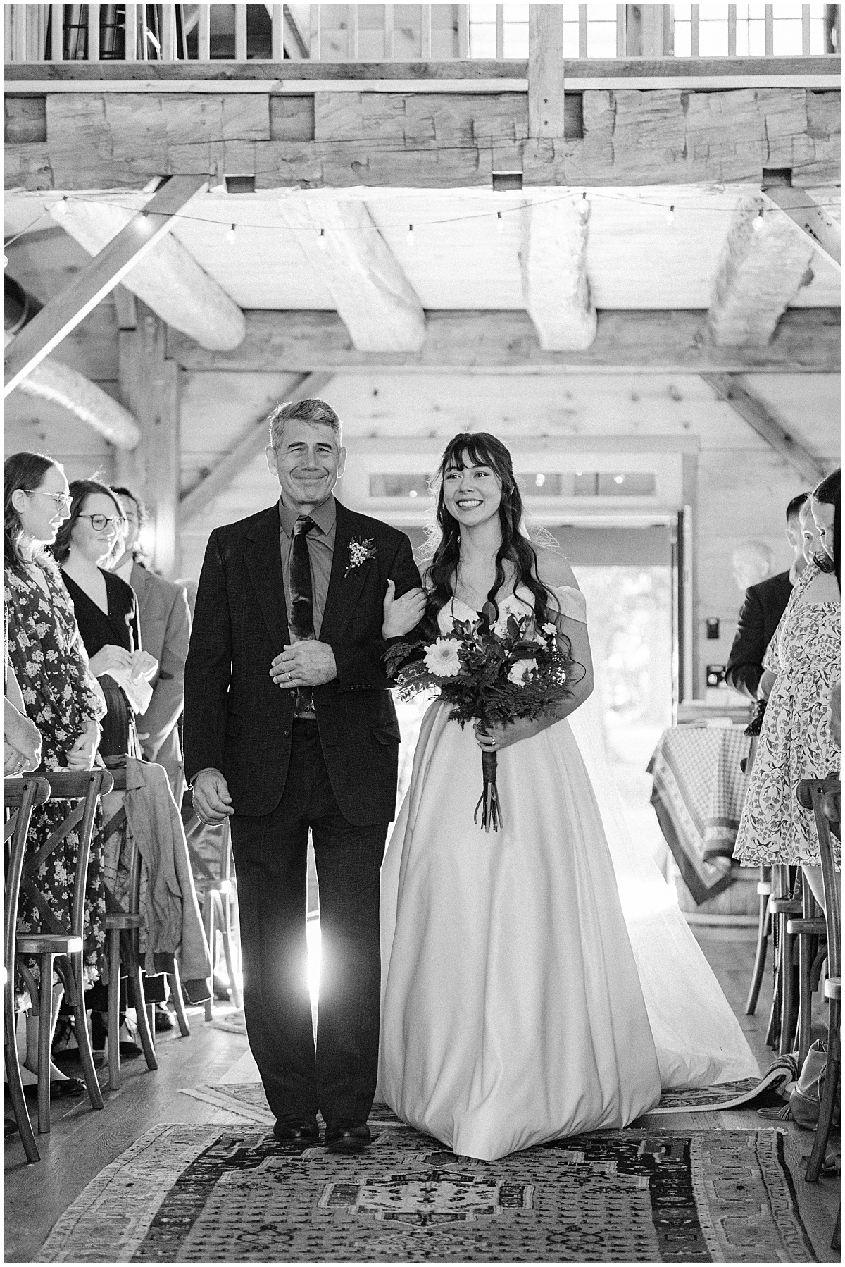 Bride walking down the aisle with father by Virginia Wedding Company