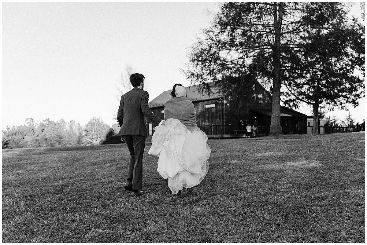Bride and groom walking away at Avon Hill by Virginia Wedding Company