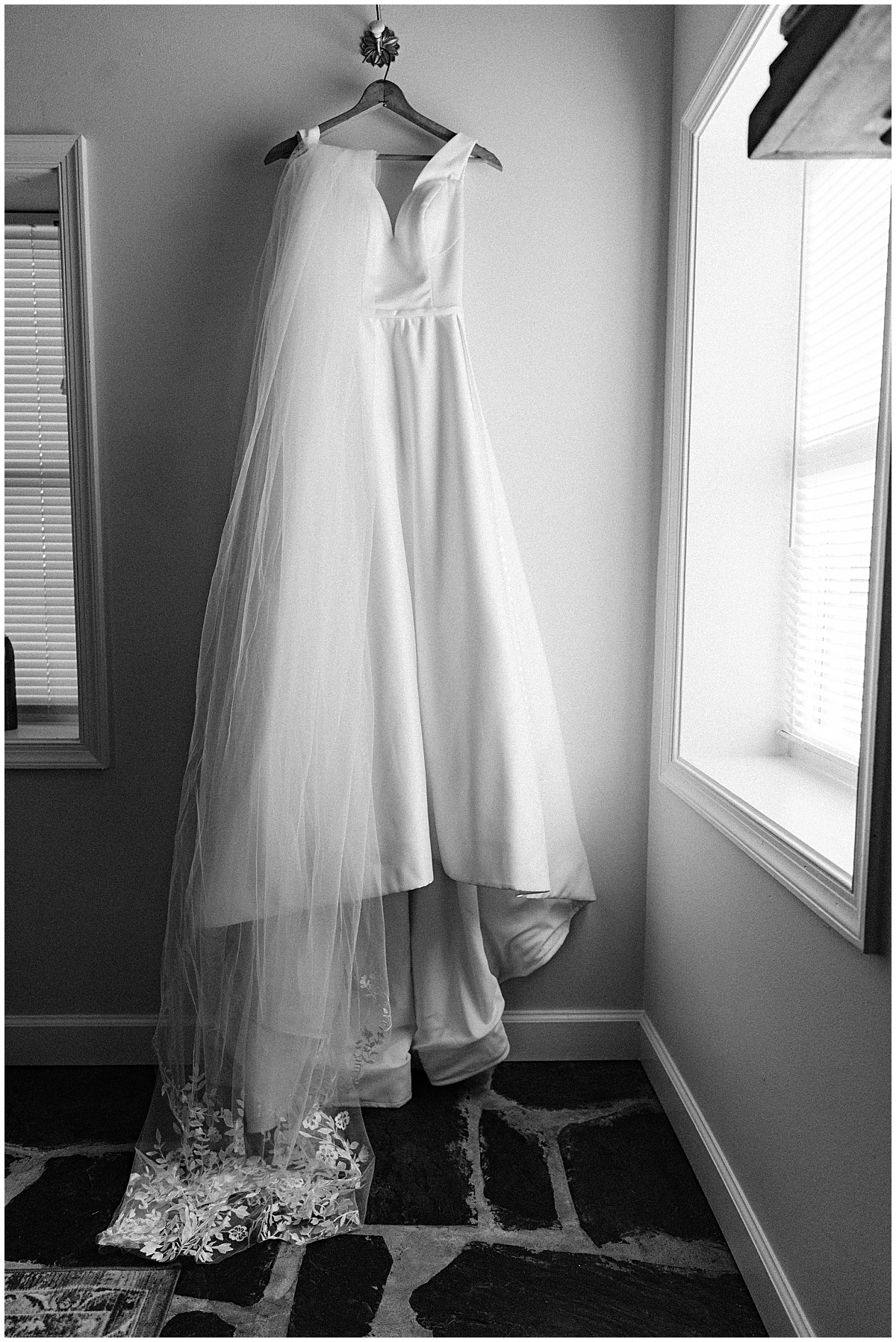 brides wedding dress hanging by Virginia Wedding Company