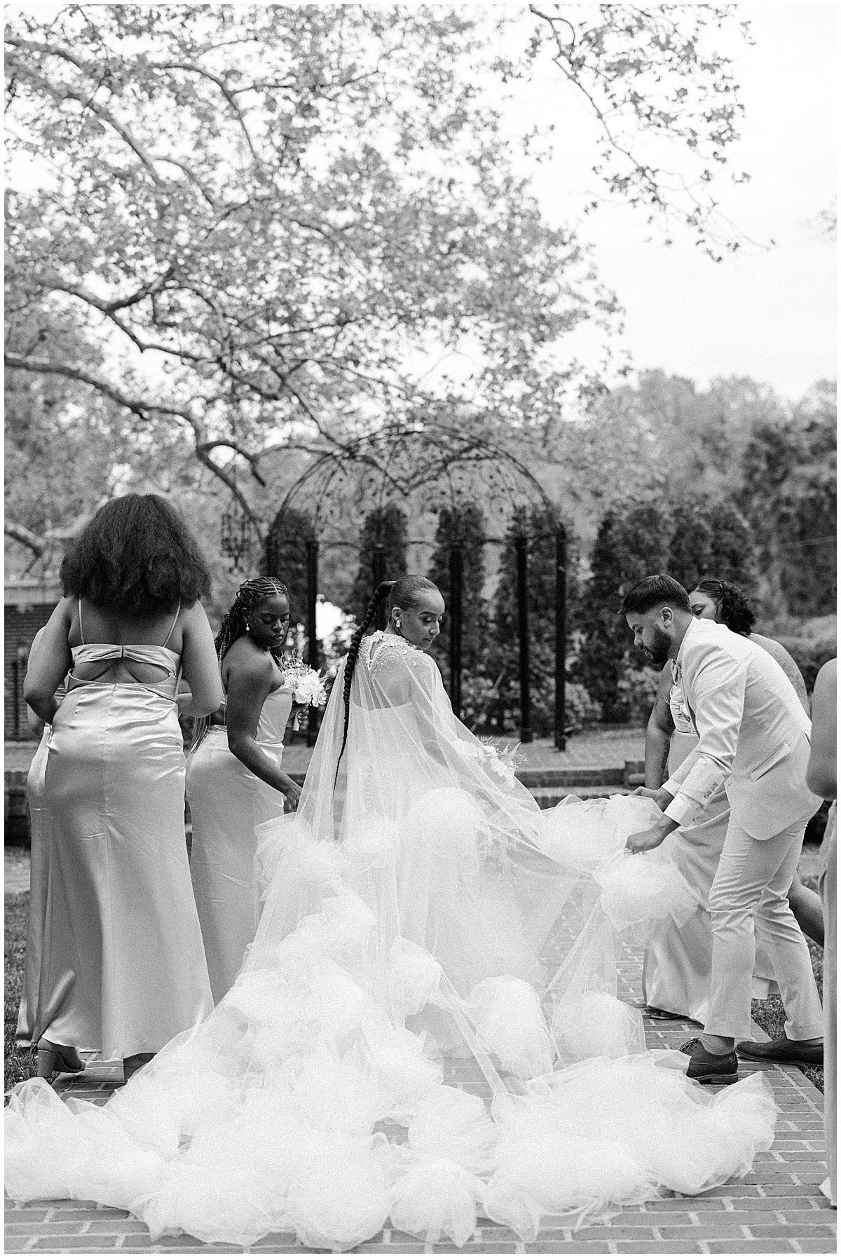 bridesmaids helping bride with dress