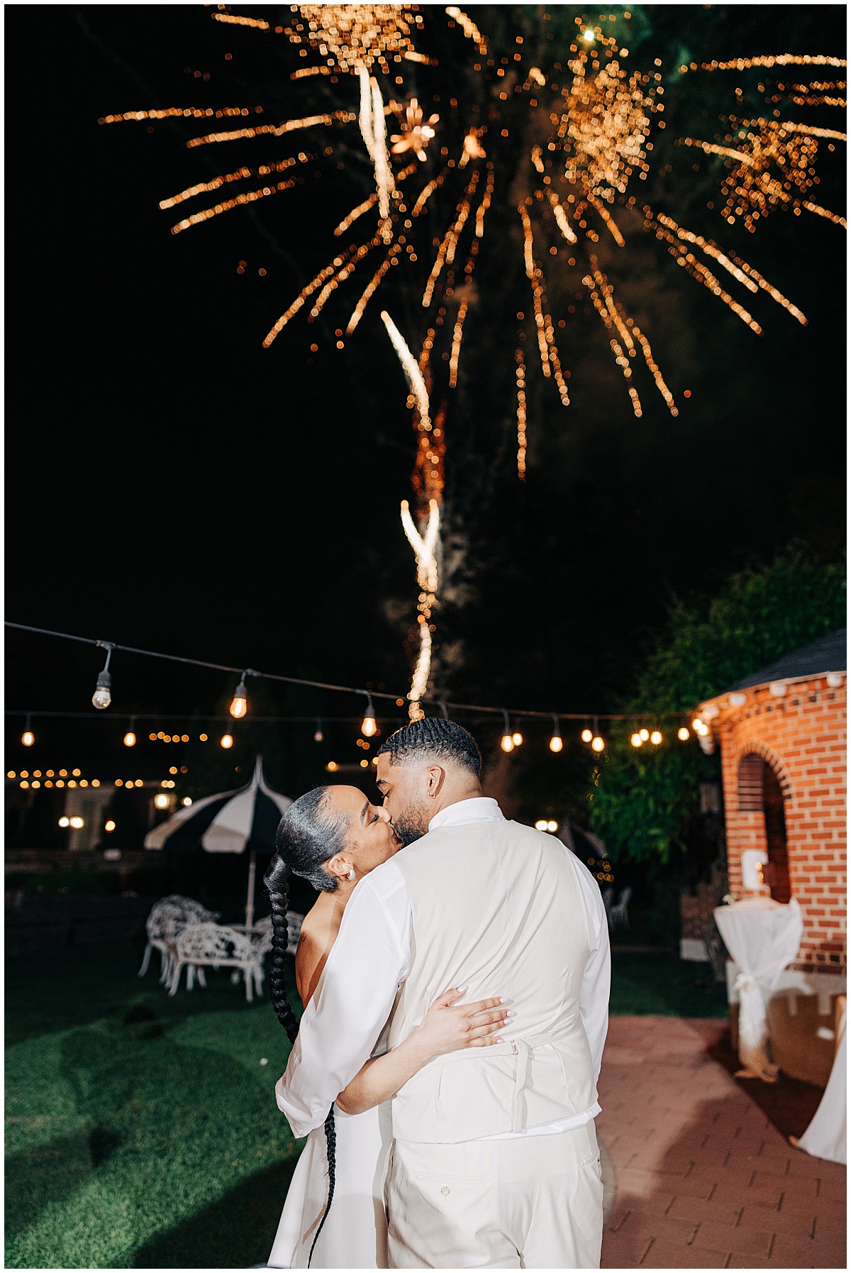 bride and groom kissing during fireworks