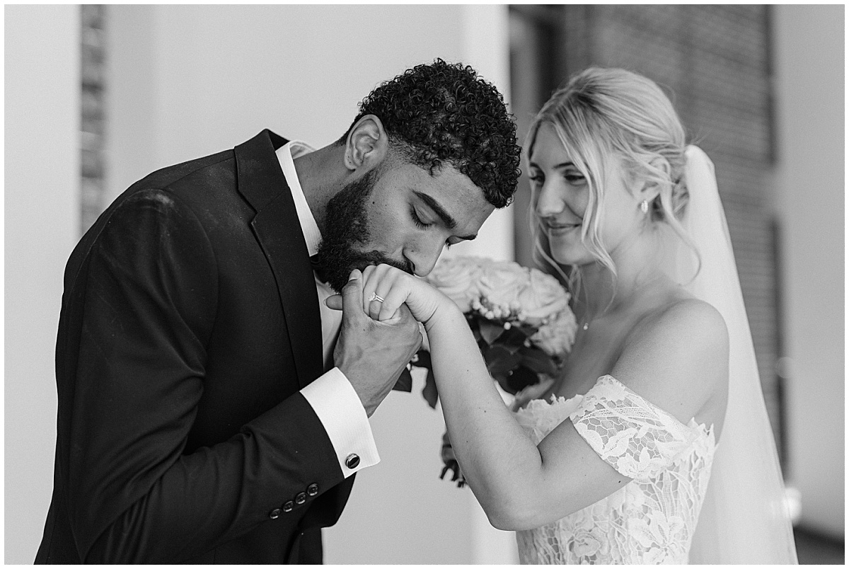 groom kissing brides hand