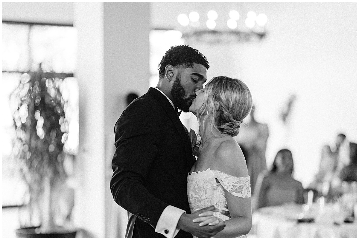 bride and groom kissing and dancing