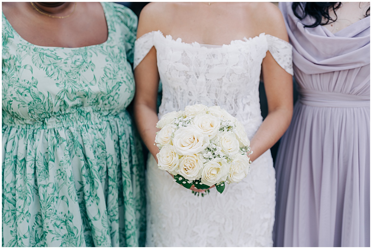 close up of brides bouquet with bridesmaids