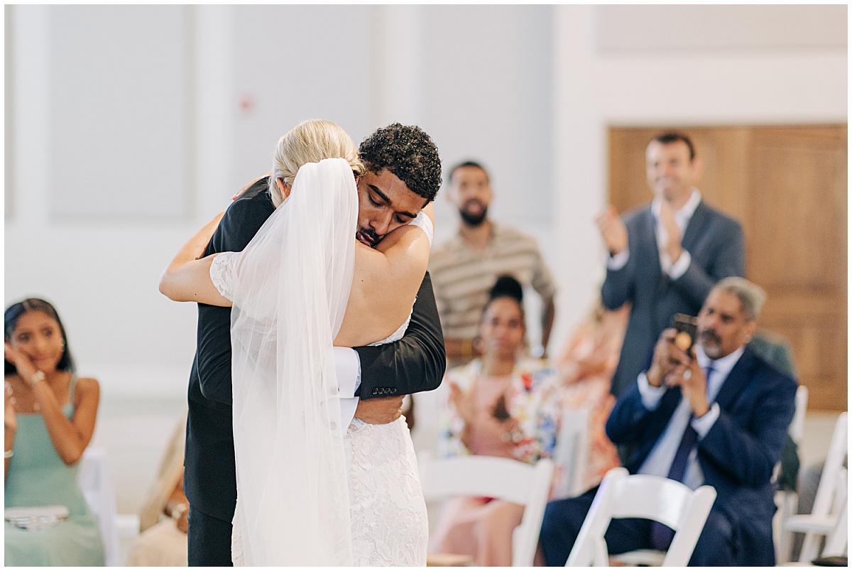 Groom and bride hugging
