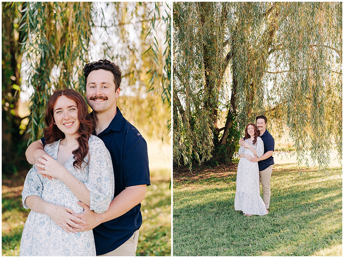 Guy holding girl under tree and smiling