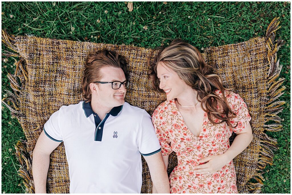 couple looking at each other lying down smiling