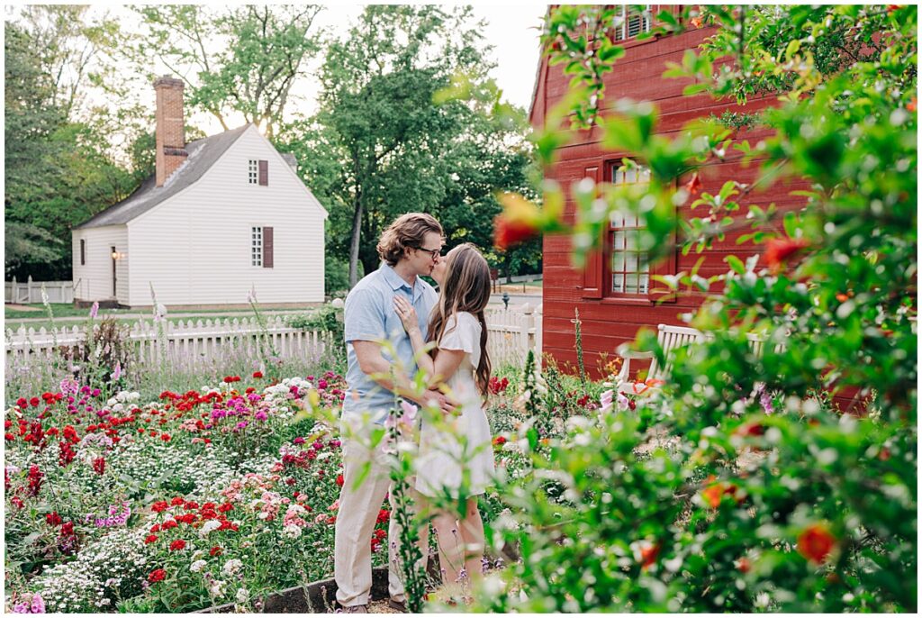 couple kissing in flower garden